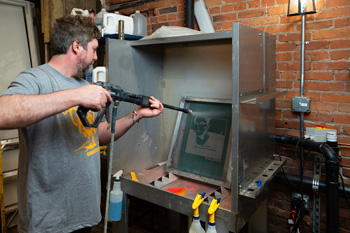 Screens are cleaned in the stainless-steel washout booth and returned to service. 